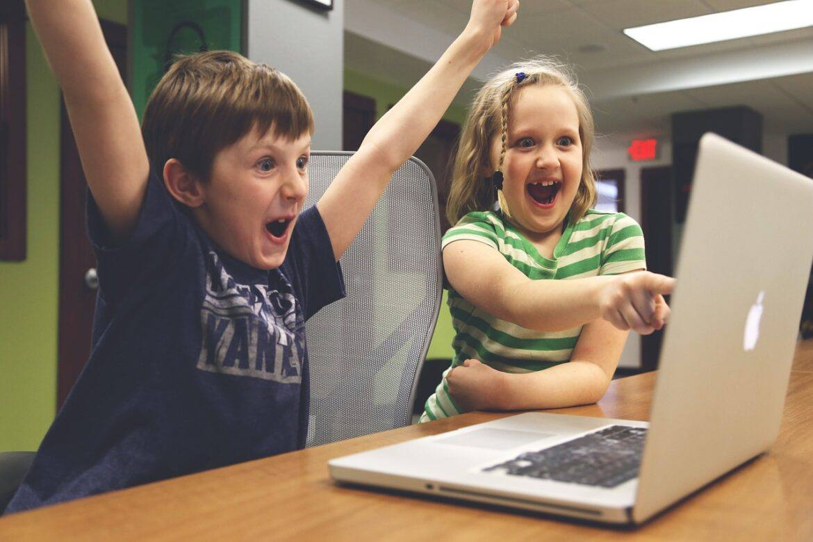 gamify Image of a young girl and boy shouting with excitement.