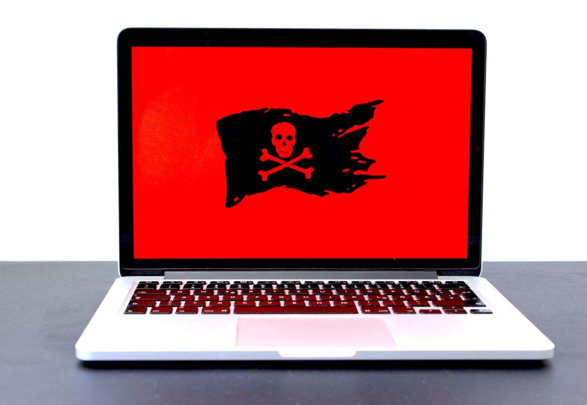 michael-geiger-JJPqavJBy_k-unsplash Pirate flag on a red background screen on laptop