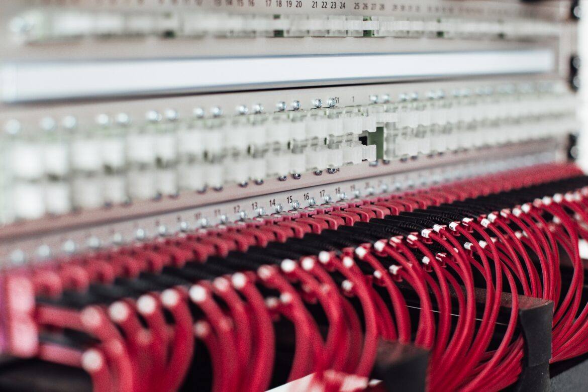 lars-kienle-IlxX7xnbRF8-unsplash network cables plugged into an network hub