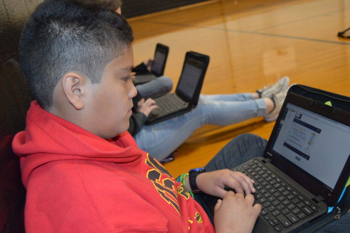 PE-002 Students engaged with Chromebooks and Canvas