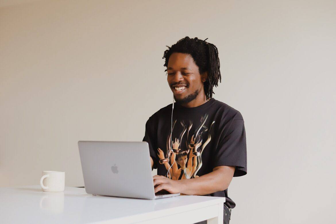 good-faces-DSj40n6beGk-unsplash black man using a laptop at a standing desk