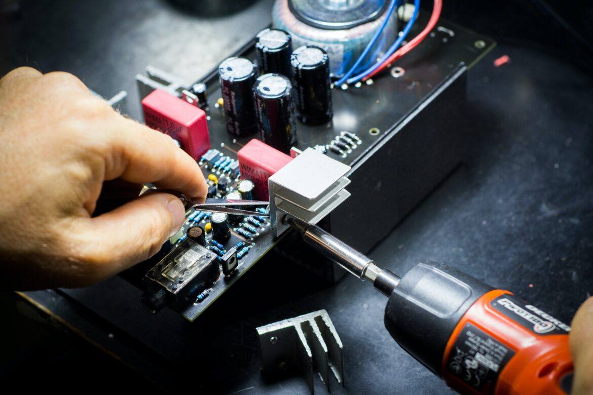 blaz-erzetic-g5f0BJq-FRs-unsplash soldering iron on a circuit on a board