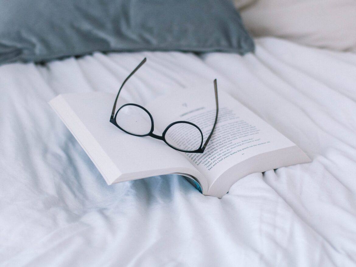 sincerely-media-c1YrcFYW66s-unsplash pair of glasses on top of open book