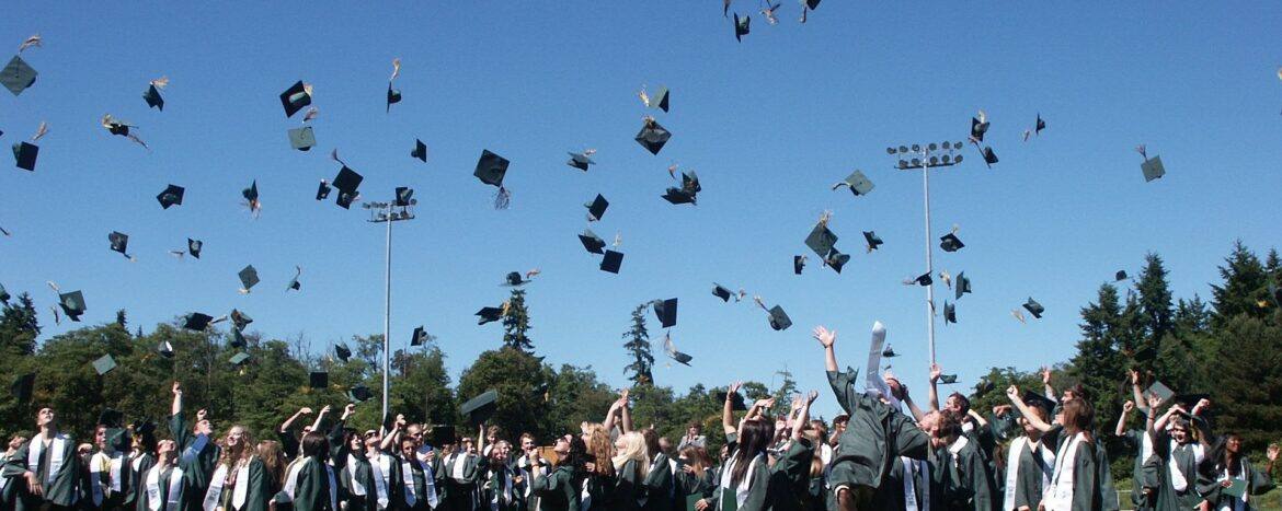 graduation Graduates throwing their caps into the air.