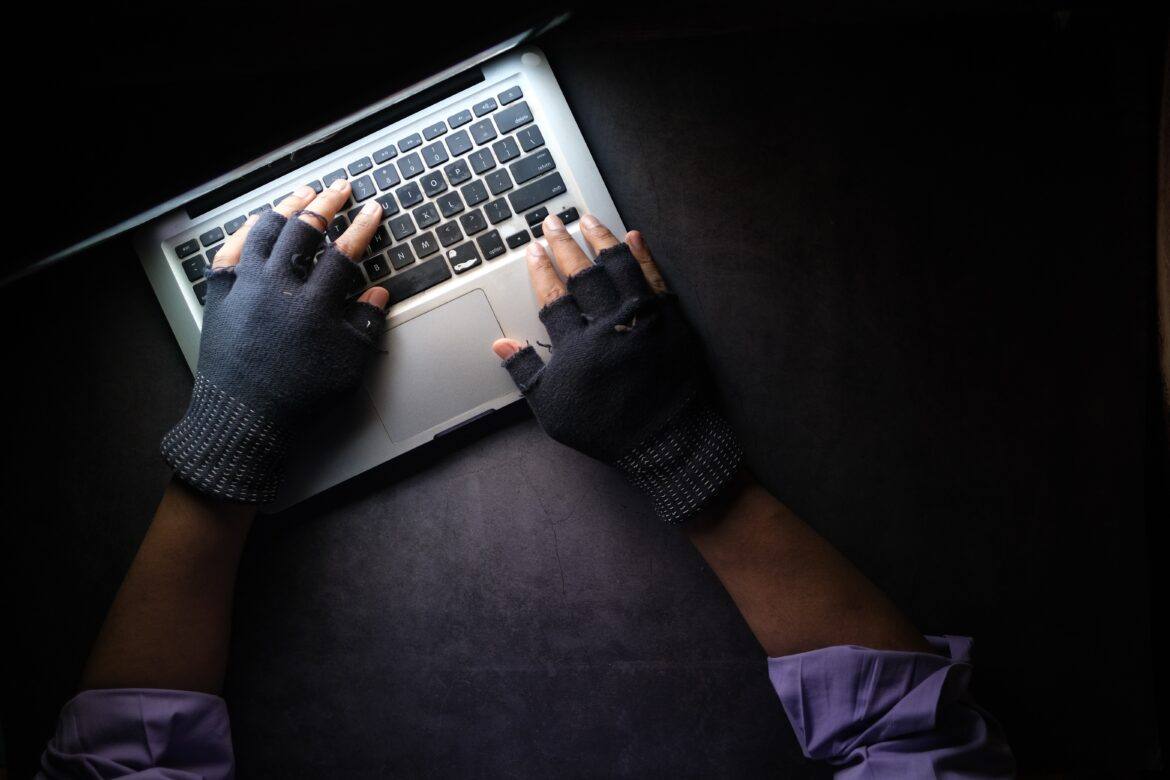 towfiqu-barbhuiya-em5w9_xj3uU-unsplash fingerless gloved hands on a laptop keyboard