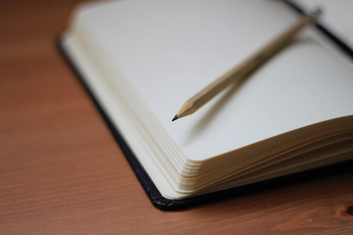 jan-kahanek-g3O5ZtRk2E4-unsplash notebook with pencil