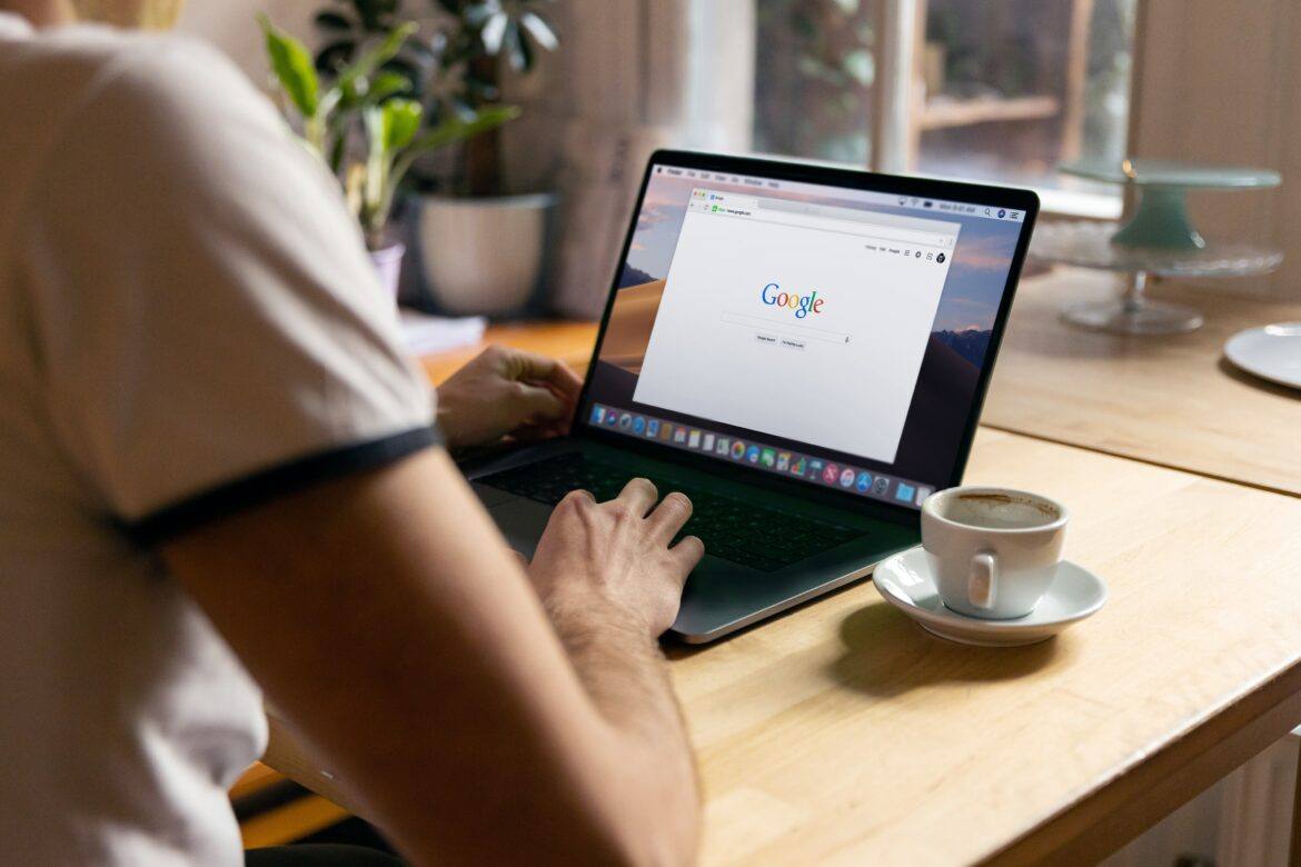 firmbee-com-eMemmpUojlw-unsplash Google browser open on laptop/chromebook with person sitting in front of it