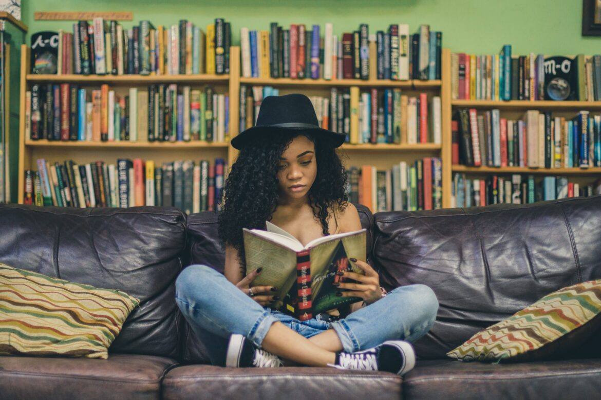 seven-shooter-hPKTYwJ4FUo-unsplash child reading on couch