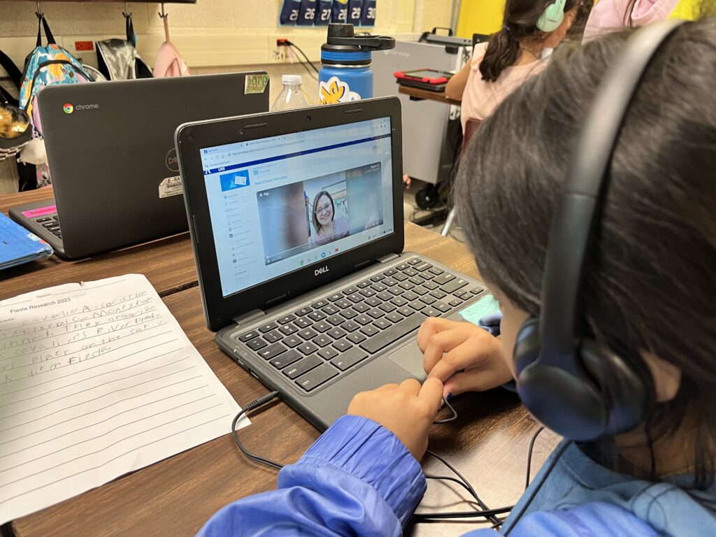 Image of student watching a video during the author study project. 