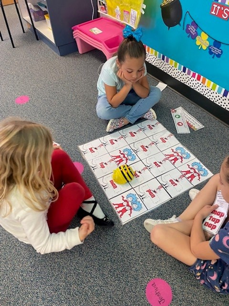 Image of students using the Bee-Bot robot for sight word practice