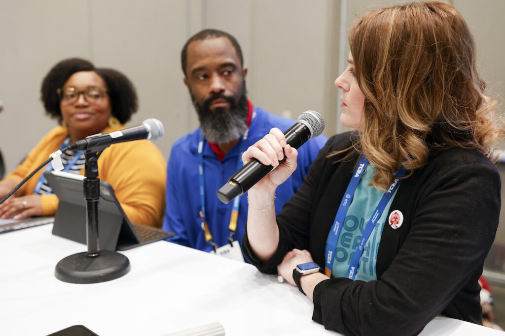 A moderator holds a microphone as she asks a panel a question. TCEA hosts a variety of professional learning events and panels.