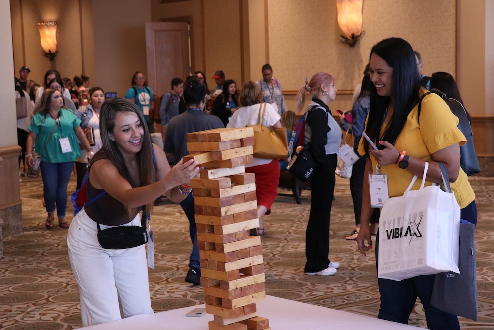 Two random ETC attendees take a break between sessions to play a friendly game of giant Jenga.