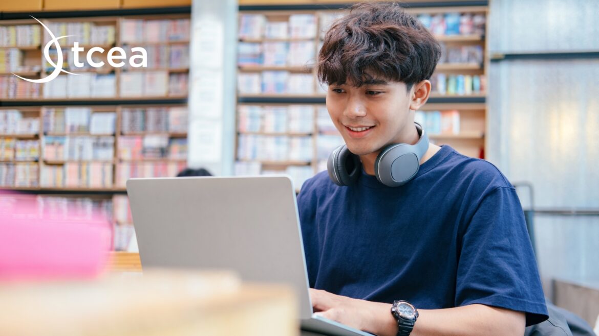 A high school student conducts research on a laptop computer in the school library.