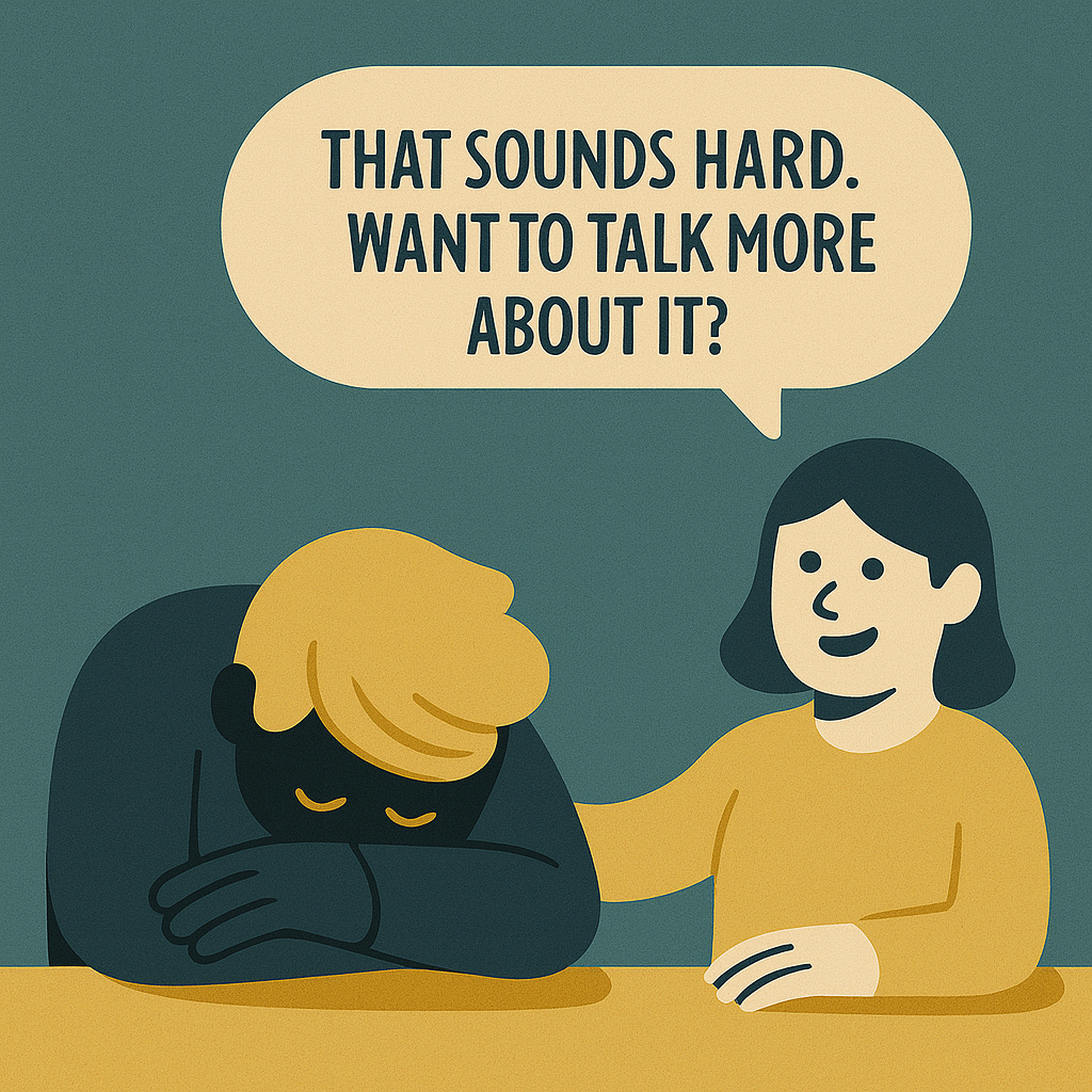 Illustration of a supportive conversation where one person comforts another who has their head down, accompanied by a speech bubble saying, "That sounds hard. Want to talk more about it?"